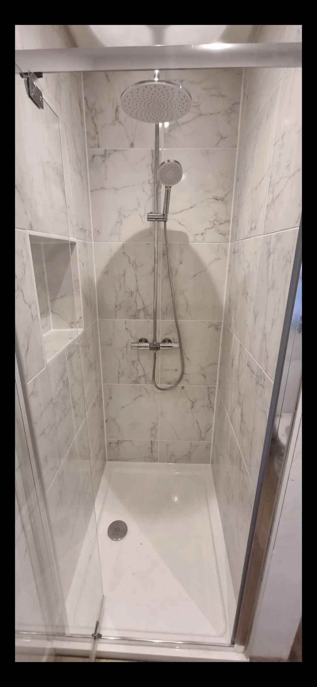 Bathroom blue metro tile shower head close-up — bathroom tilers Surrey
