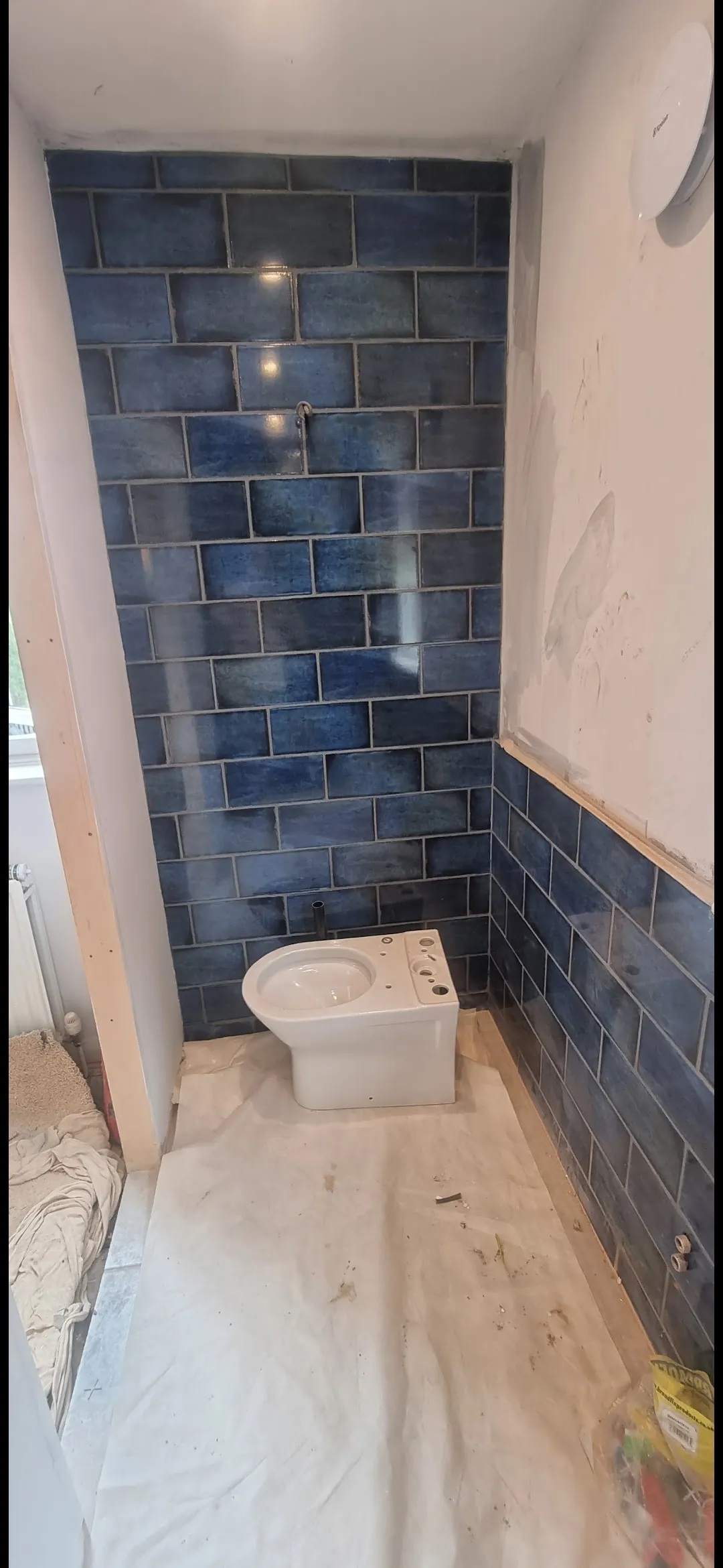 Bathroom blue metro tile WC toilet installation in progress — bathroom contractors Surrey