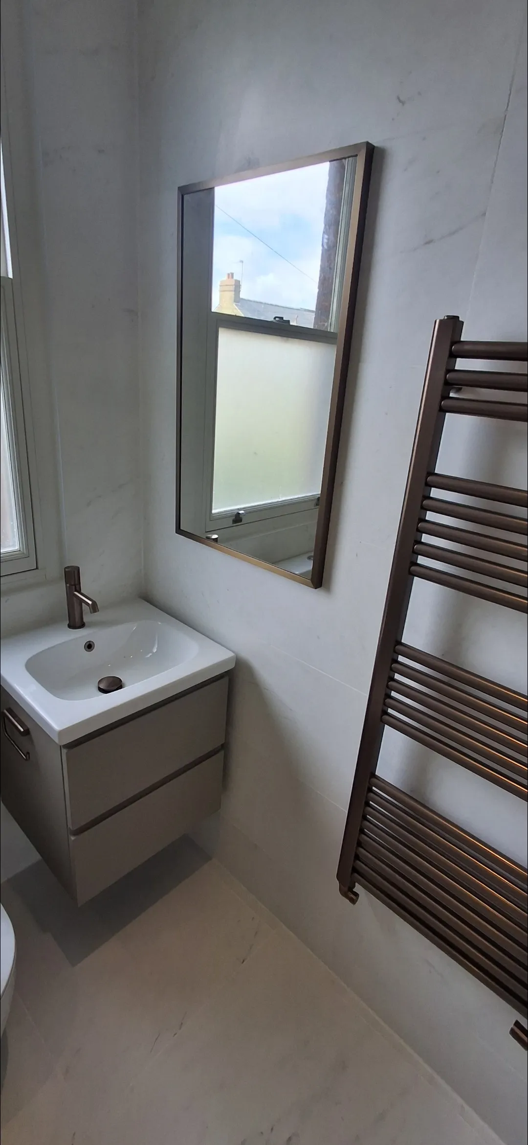 Bathroom white marble vanity, mirror and bronze towel rail — bathroom renovation Surrey