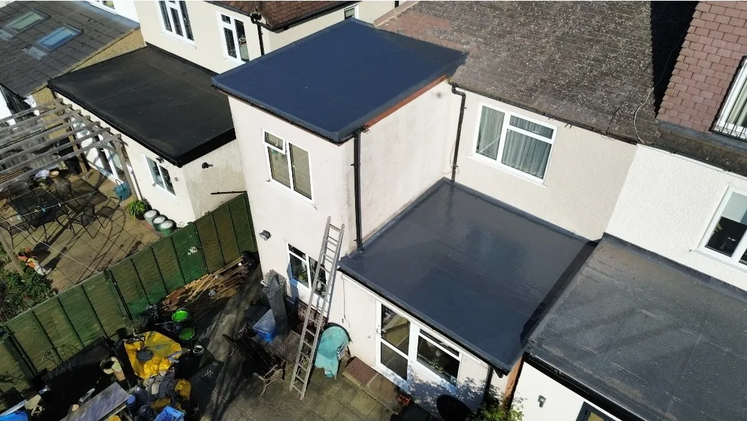 Dark anthracite GRP flat roof two-storey extension aerial — flat roof contractors SW London