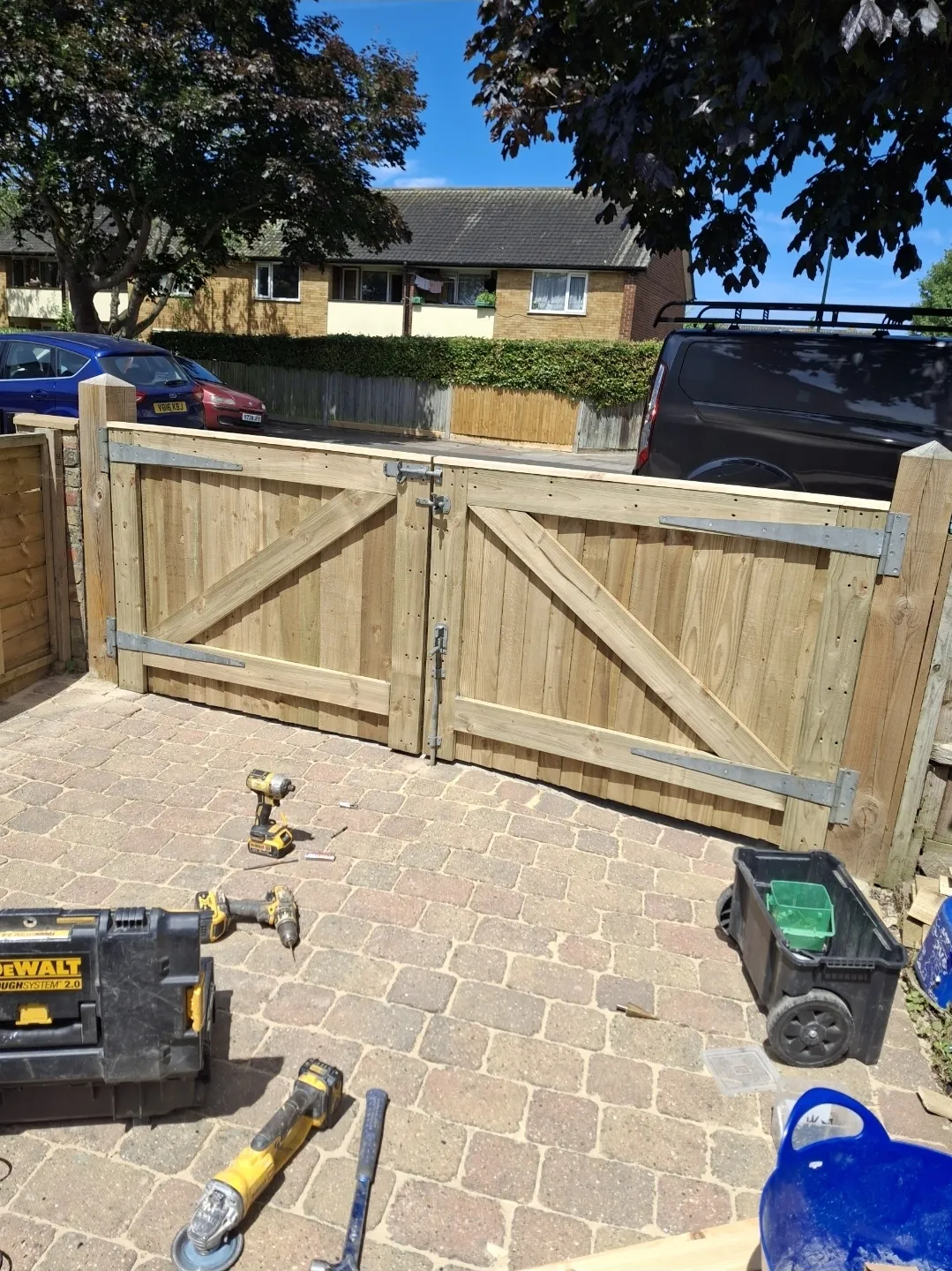Double timber driveway gates with ironmongery and block paving — builders Surrey