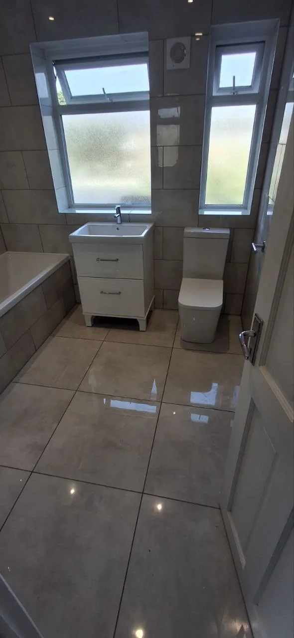 Full bathroom suite installation with grey tiles — bathroom renovation Surrey