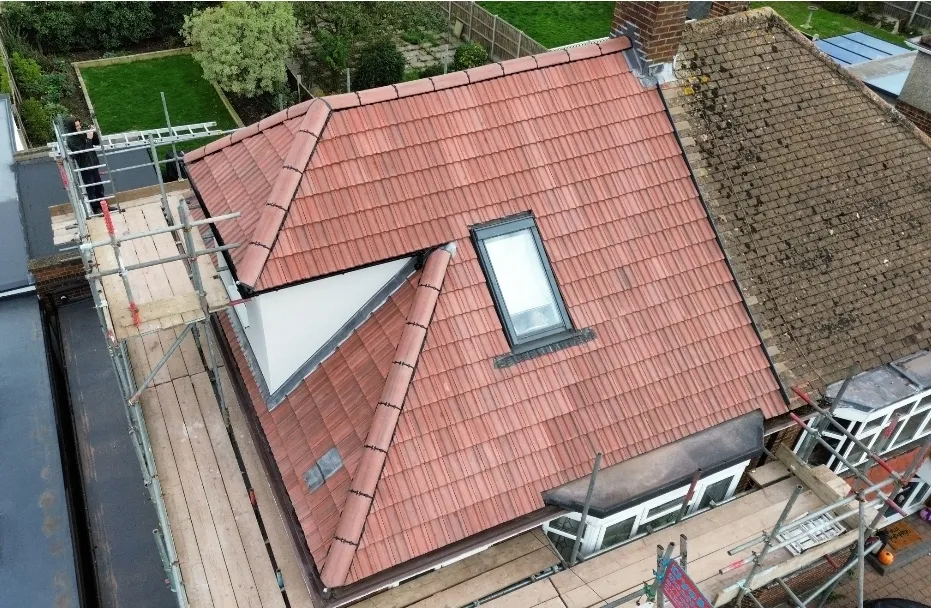 Pitched red tile dormer and Velux completed aerial with scaffolding — roofers SW London