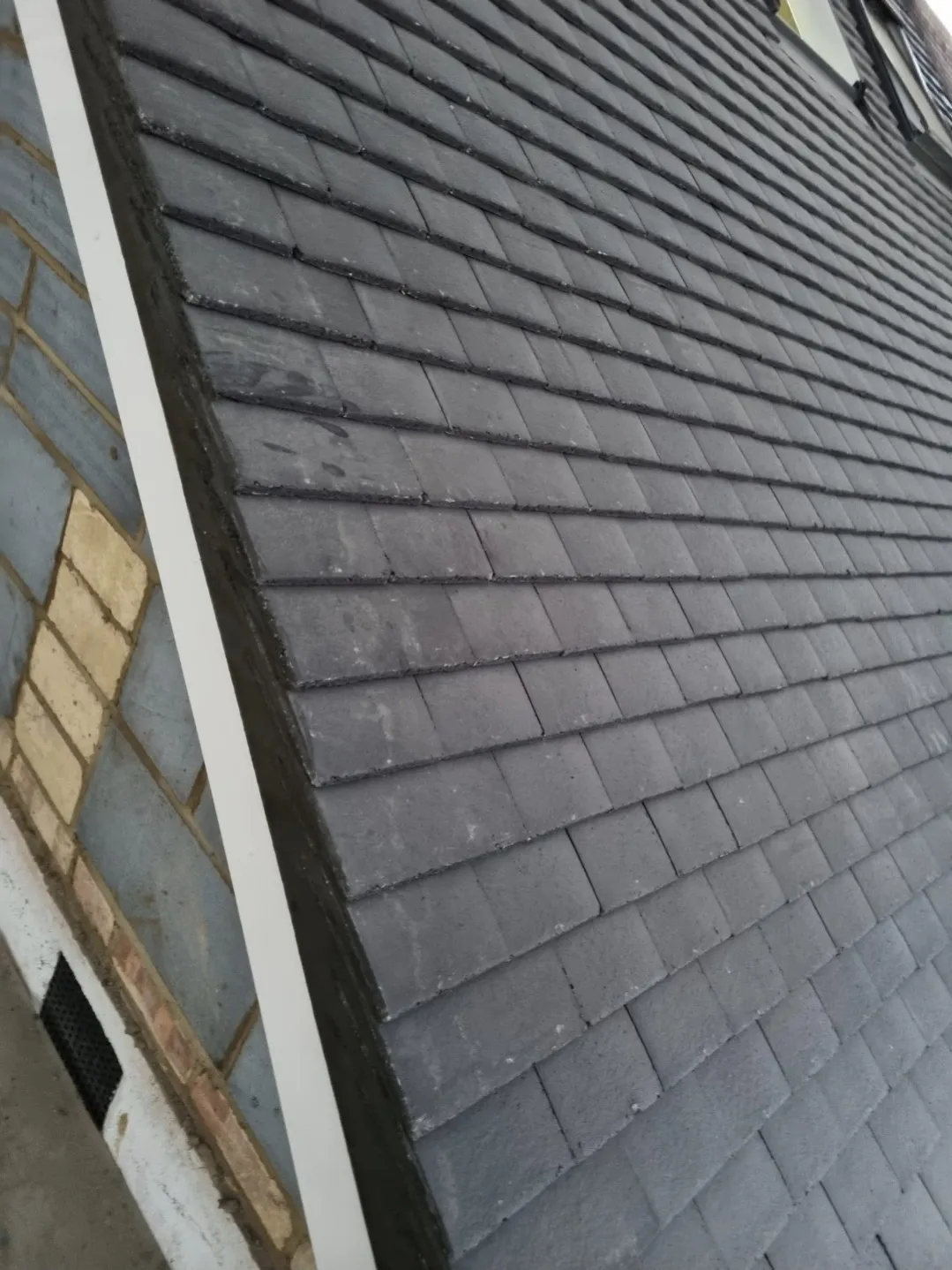 Slate effect tile roof hip close-up detail — roofing contractors Surrey