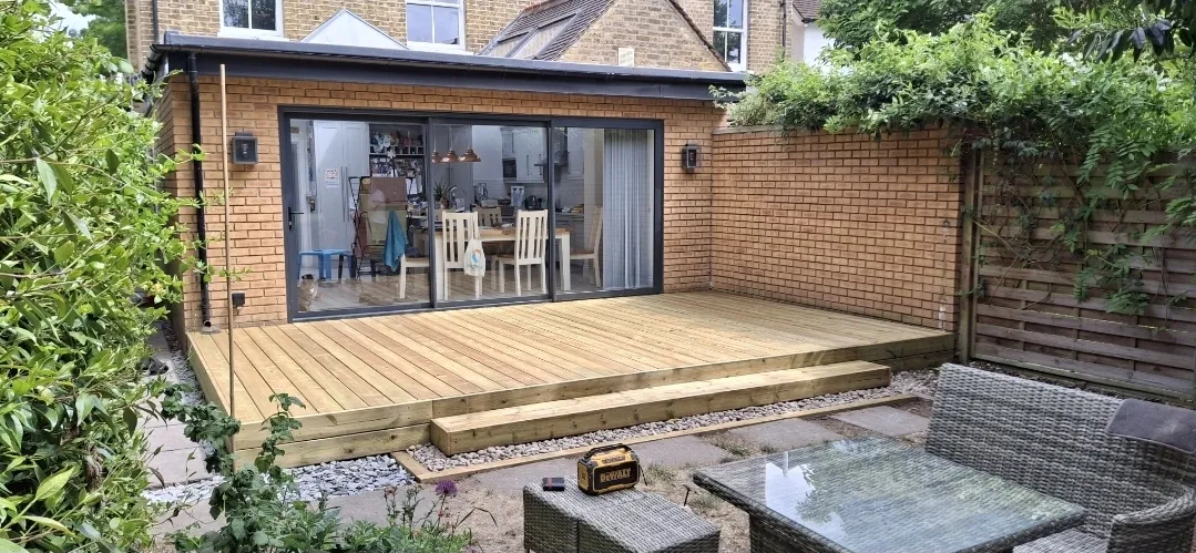 Timber deck and garden room extension with sliding doors — builders SW London