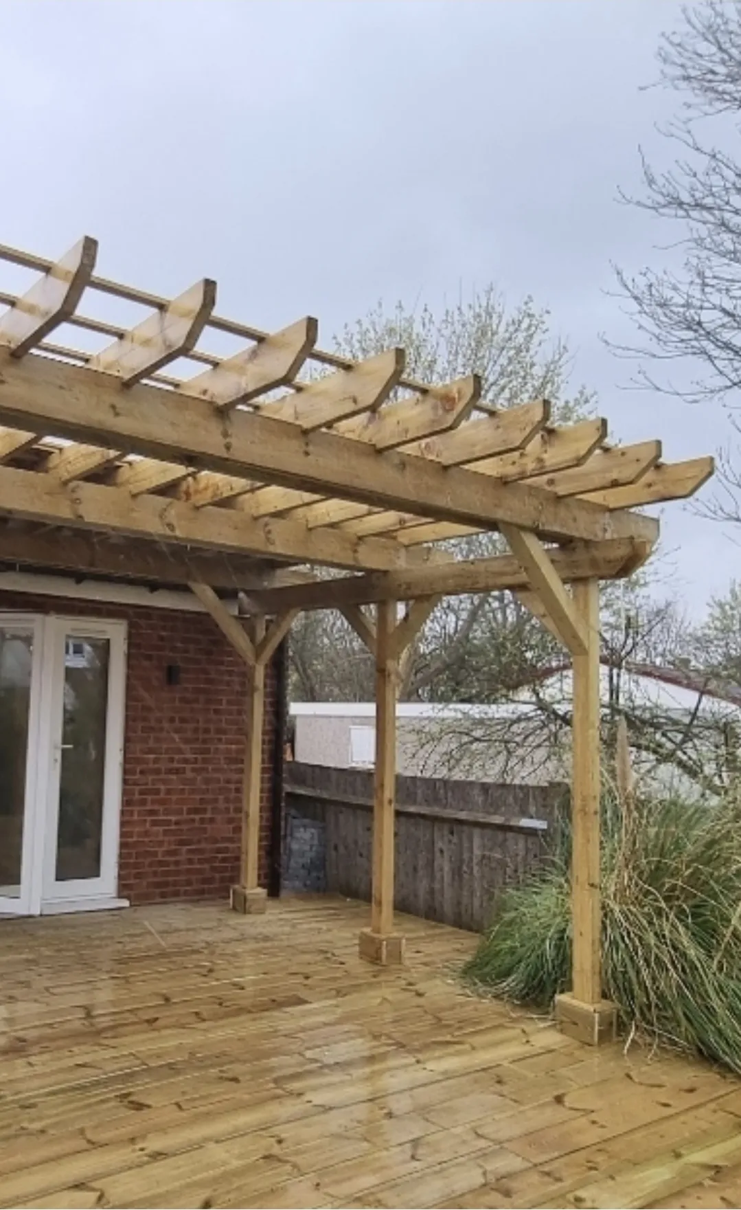 Timber pergola and decking wide angle — landscaping contractors Surrey
